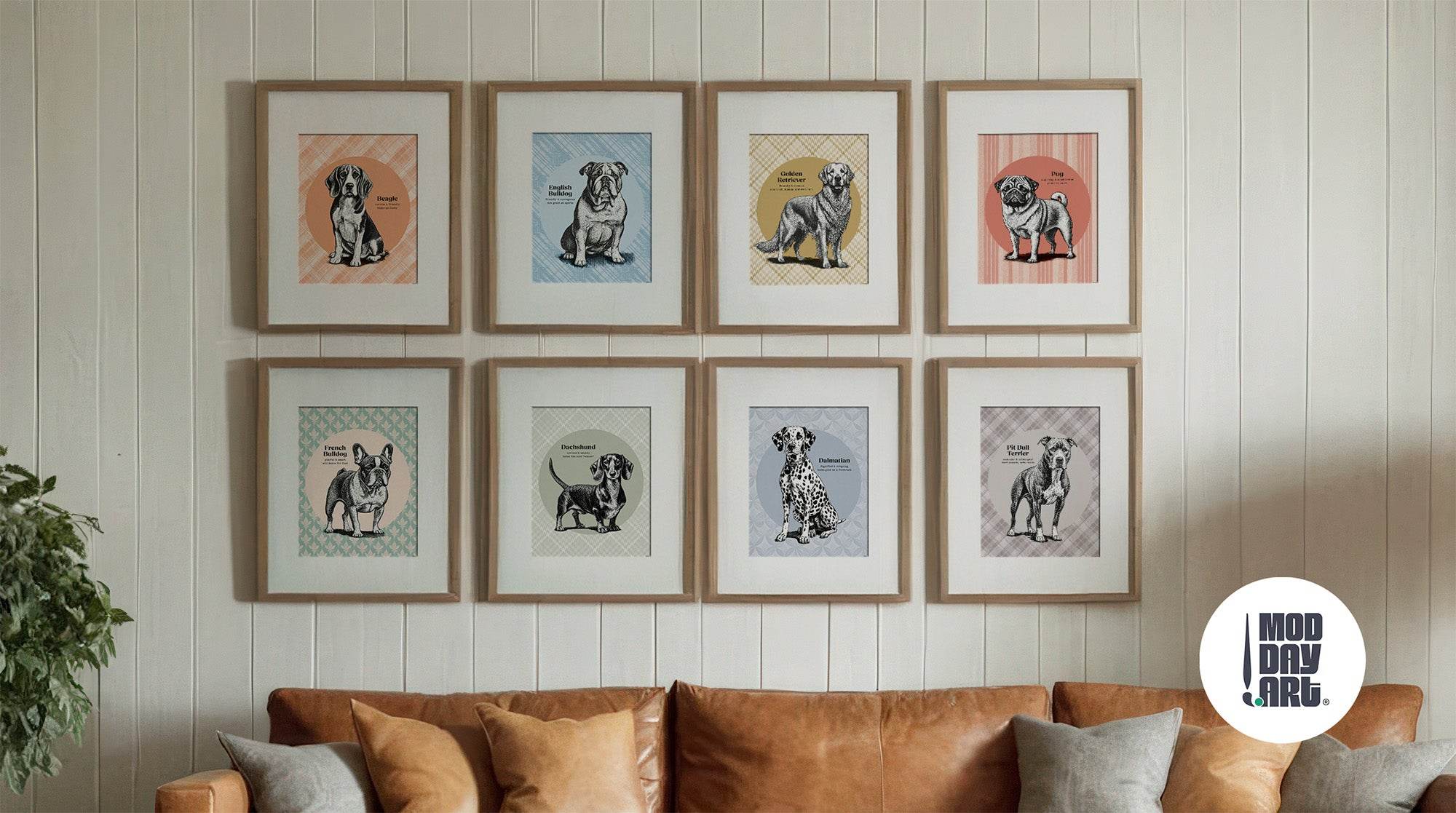Eight framed vintage dog breed art prints in wood frames arranged in gallery wall above tan leather sofa, featuring Beagle, English Bulldog, Golden Retriever, Pug, French Bulldog, Dachshund, Dalmatian, and Pit Bull illustrations with colorful geometric backgrounds.