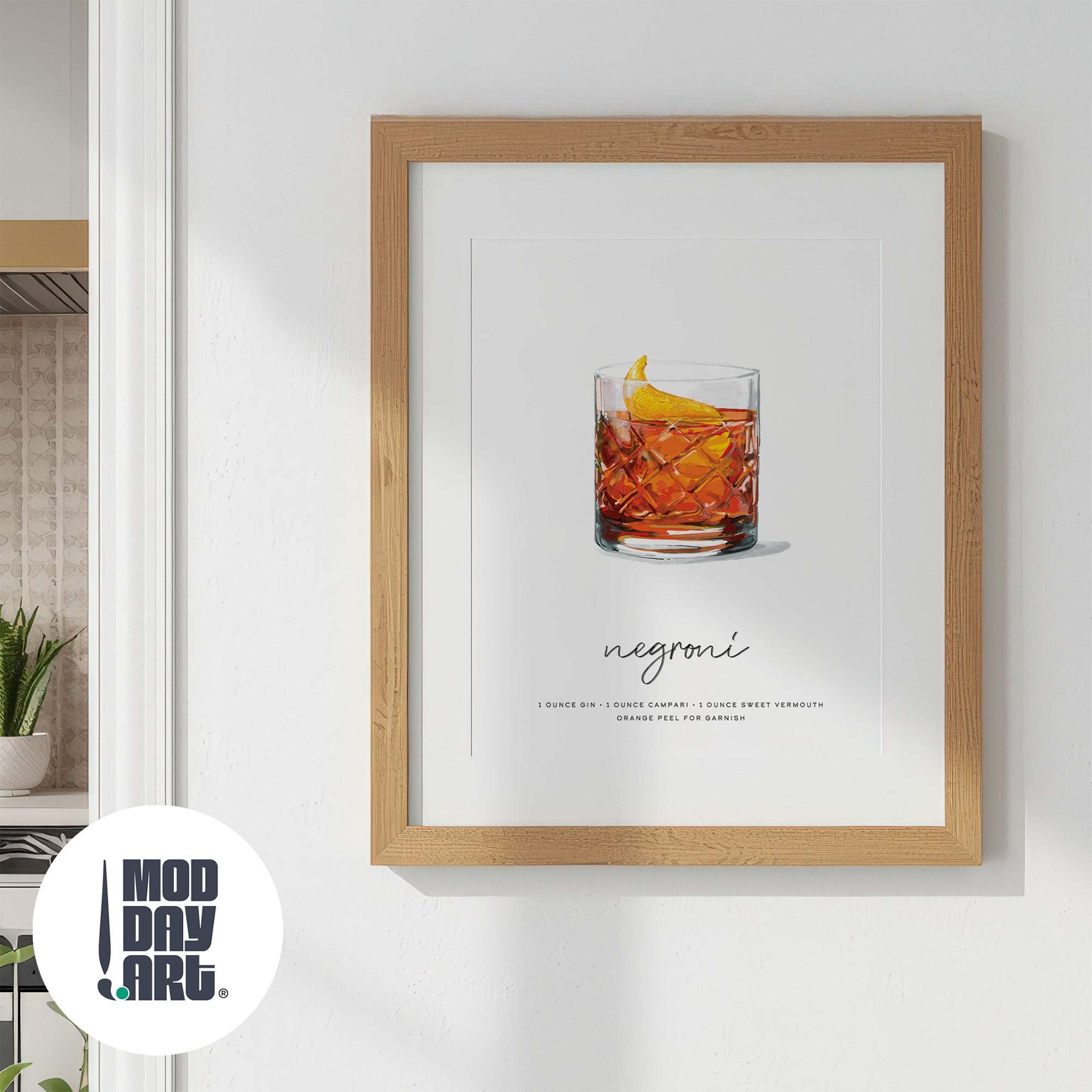 Framed print of a Negroni recipe cocktail wall art with a wooden frame on a white wall.