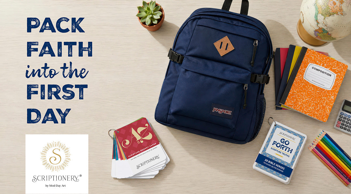 Pack faith into the first day. Scriptionery ABC and Go Forth Scripture card decks laid out with a navy backpack, colored pencils, a notebook and a globe.