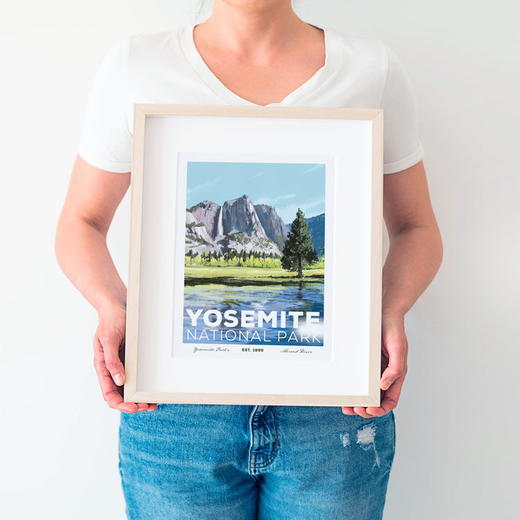 Yosemite National Park poster, 8x10, displayed in a frame held by a woman wearing a white shirt and blue jeans.