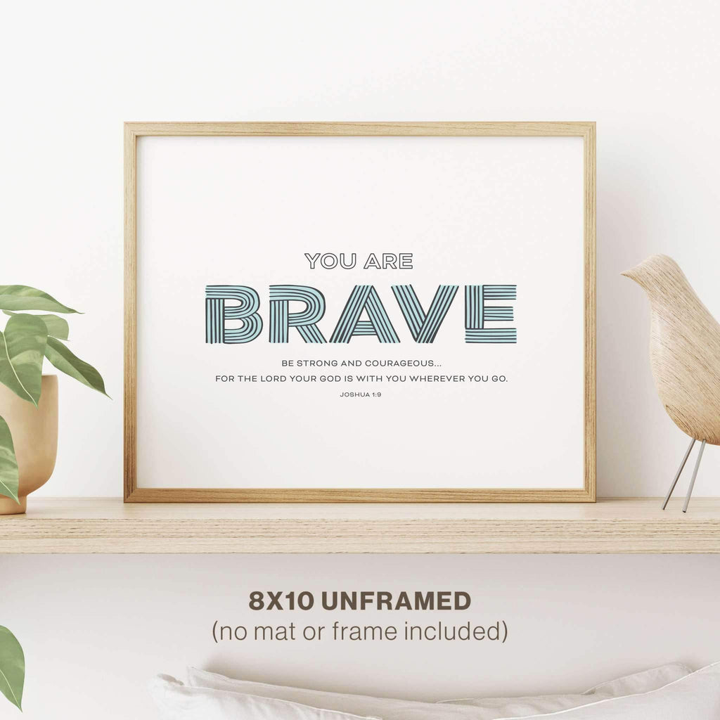 Close-up of Scriptionery™ “Brave” nursery wall art from the set, featuring an inspirational Christian design, elegantly framed and displayed in a child's nursery.