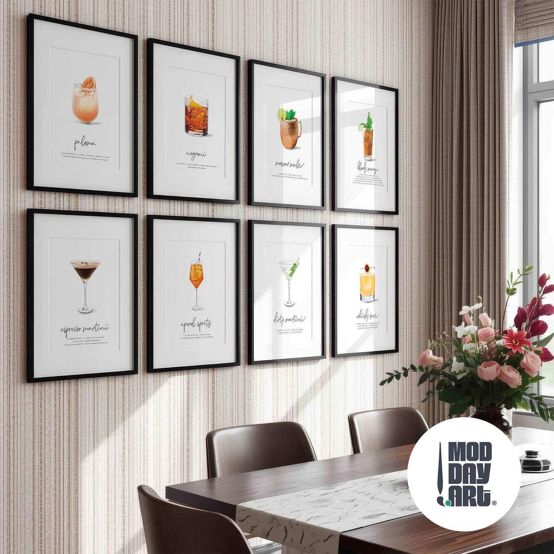 Framed cocktail illustrations on a wall above a dining table with a 'Mod Day Art' logo.