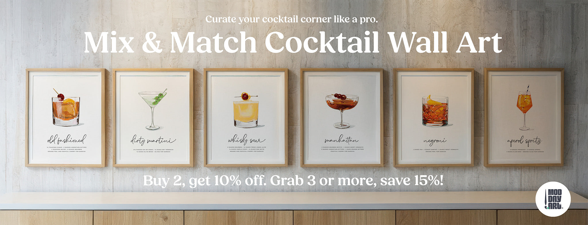 Framed cocktail wall art prints displayed on a light wood wall—Old Fashioned, Dirty Martini, Whiskey Sour, Manhattan, Negroni, and Aperol Spritz—promoting Mod Day Art’s mix and match bar decor with a discount offer