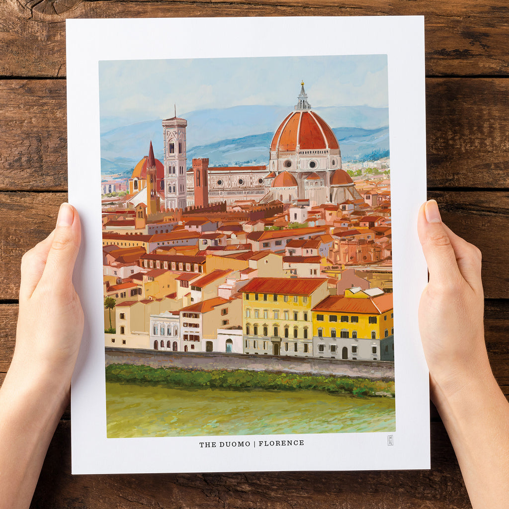 Art print of Florence held by hands on a wooden surface