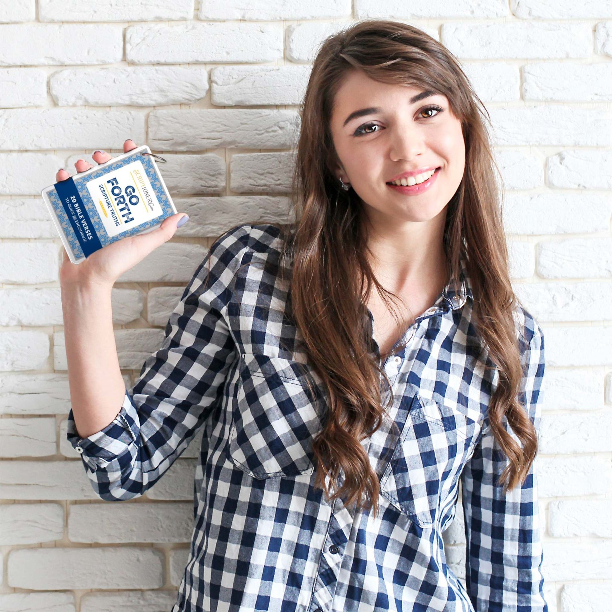 Young female student holding Bible Verses to Memorize, Go Forth Scripture Memory Cards for Students