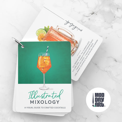 Cocktail recipe cards titled 'Illustrated Mixology' on a marble surface with a cocktail illustration on the cover.