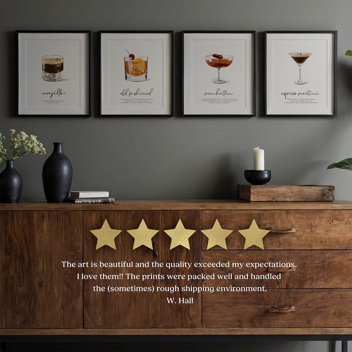 Four framed cocktail prints on a wall above a wooden console table with a five-star rating and review.