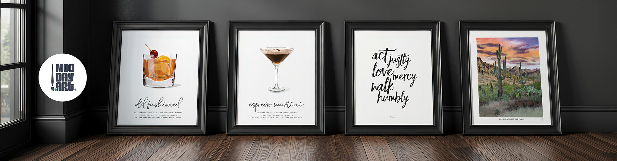 Five framed Mod Day Art prints on a wooden surface with a dark wall background