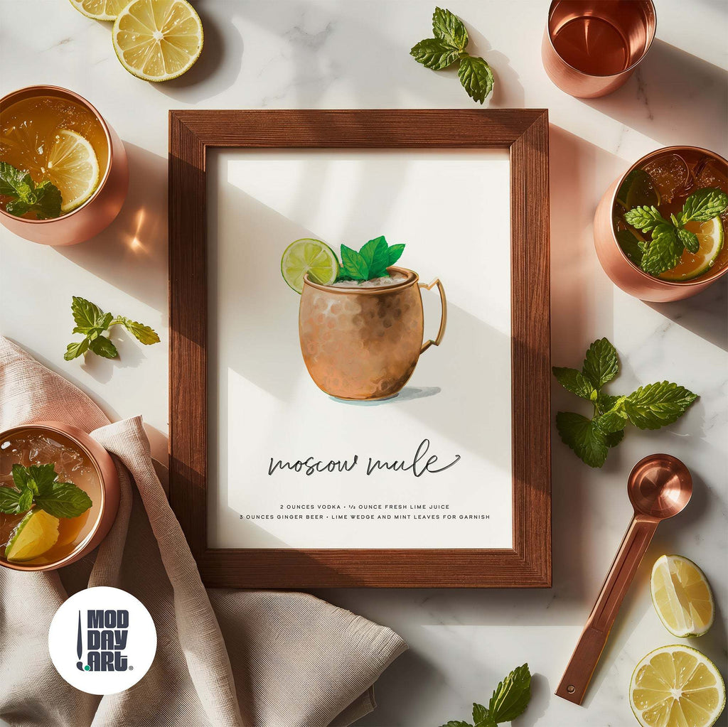 Framed Moscow Mule recipe cocktail wall art poster with copper mugs, lemons, and mint leaves on a marble surface.