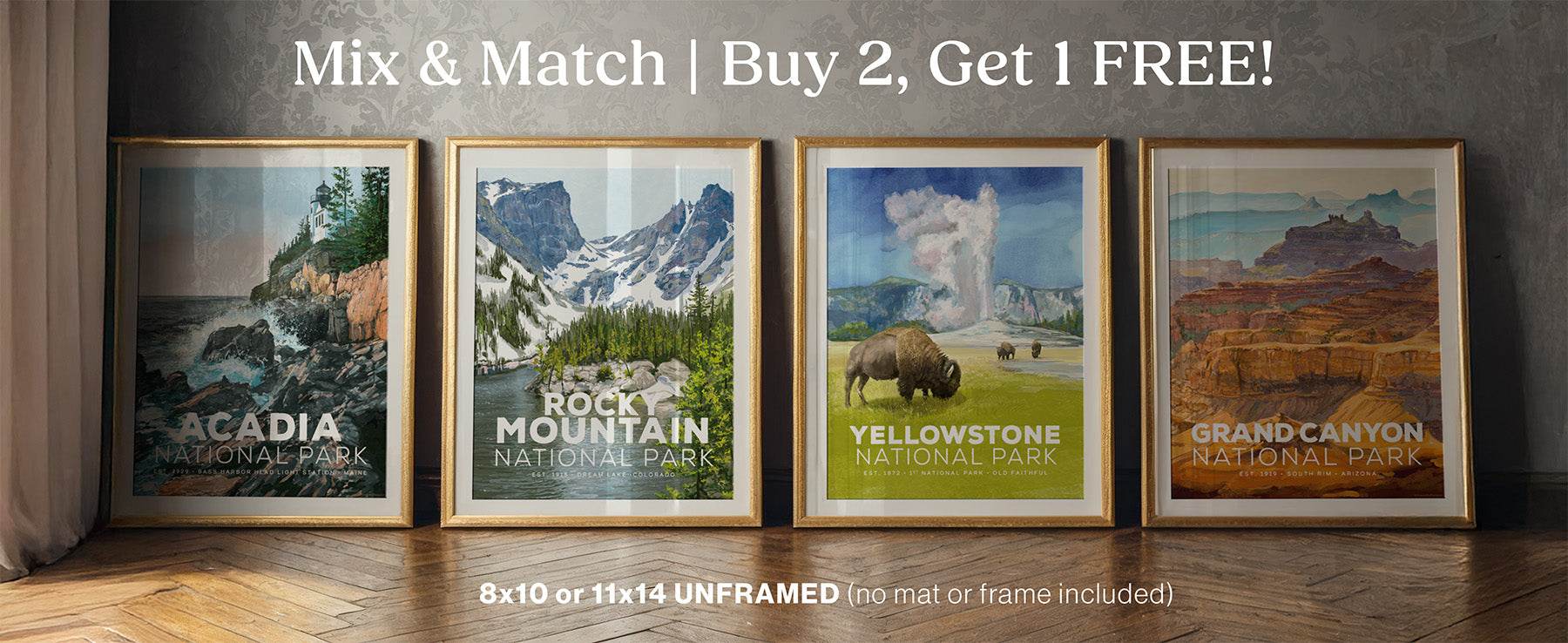 Four framed prints of national parks with promotional text on a wooden surface.
