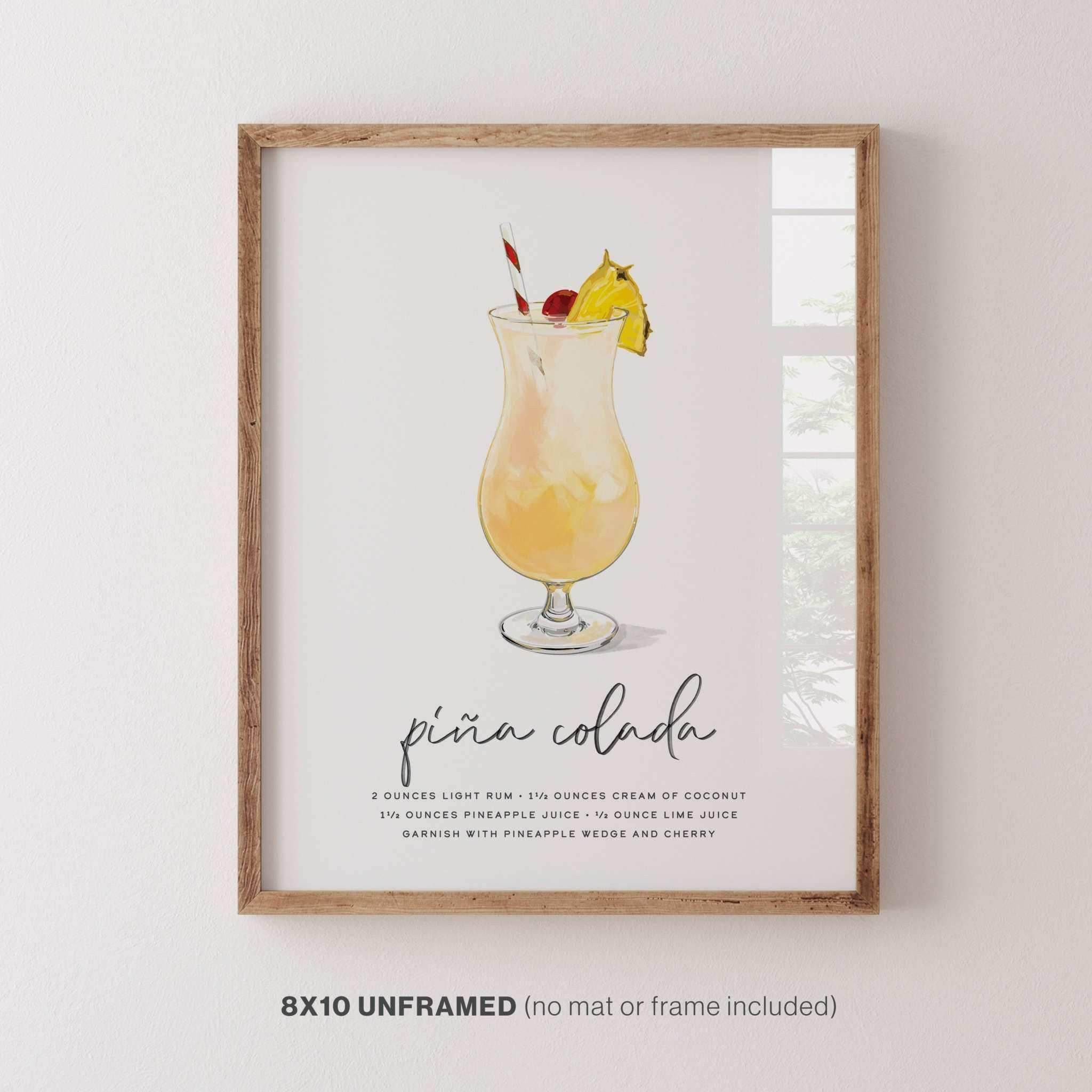 Piña Colada cocktail wall art, 8x10 inches, displayed in a frame on a wall for stylish decor.