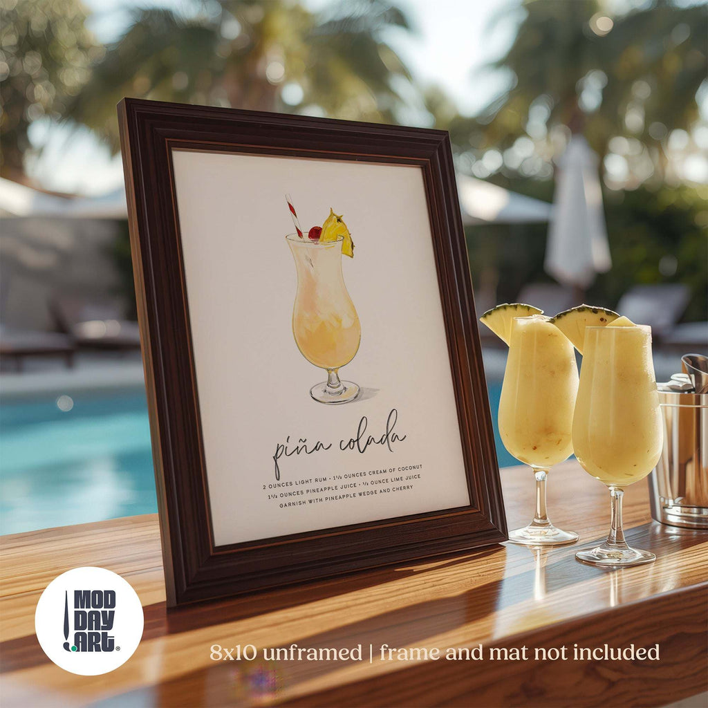 Framed Pina colada recipe cocktail wall art poster with glasses of the drink in the background.