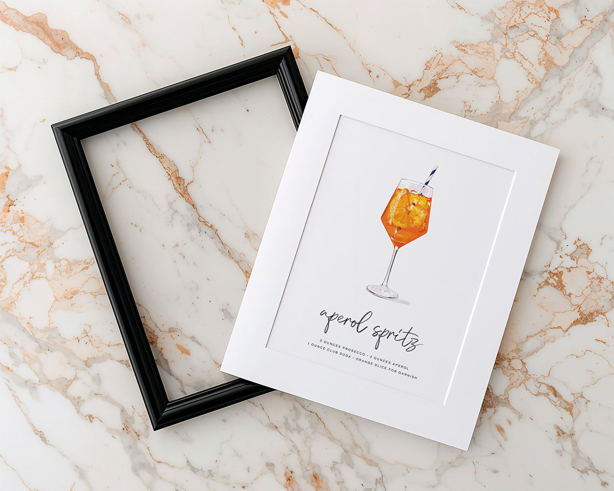 Unassembeld frame with a print of a Mod Day Art cocktail recipe wall art illustration on a marble surface
