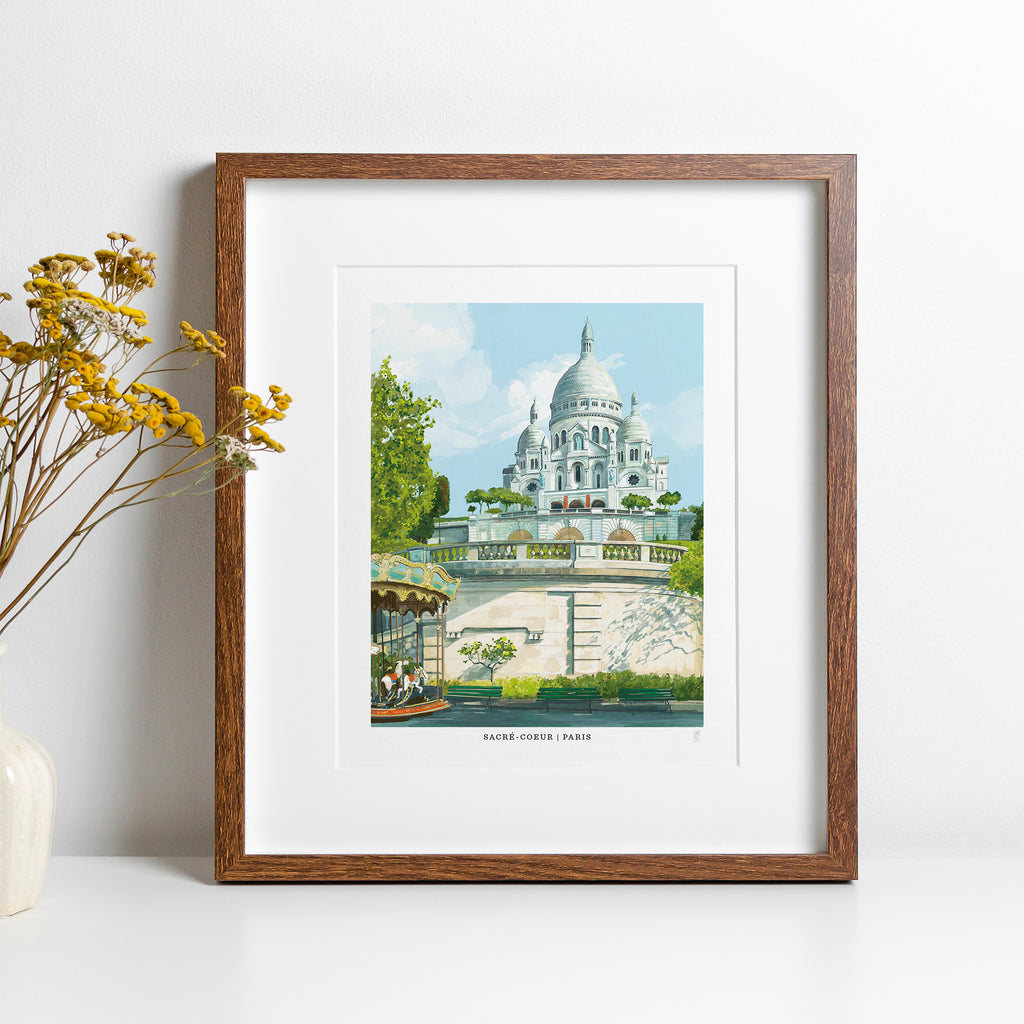 Framed artwork of a Sacre Coeur Paris with a wooden frame on a white surface.