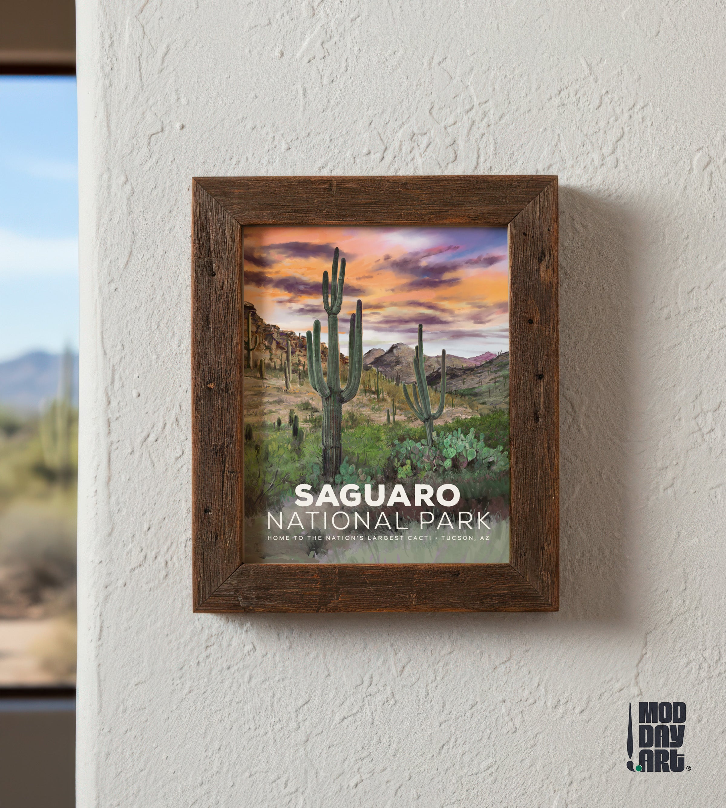 Framed artwork of Saguaro National Park with a wooden frame on a white wall.