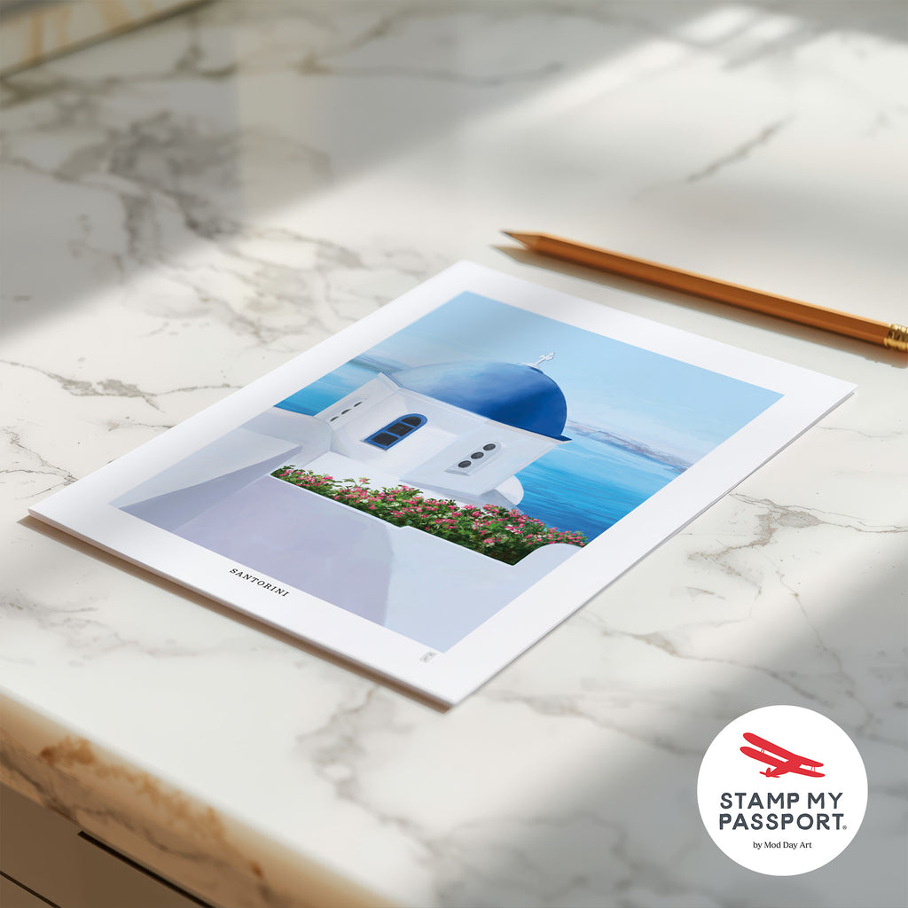 Hand-signed Santorini travel poster with a scenic design on a marble surface, featuring 'Stamp My Passport' logo.