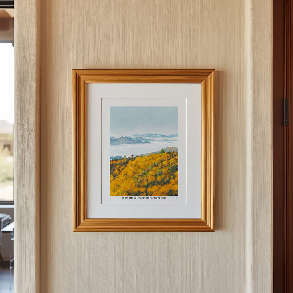 Framed artwork of a Smoky Mountain National park landscape with trees and water on a beige wall.