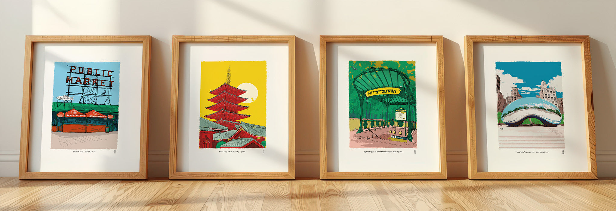 Four framed city art prints by Mod Day Art on a wooden floor leaning against a wall