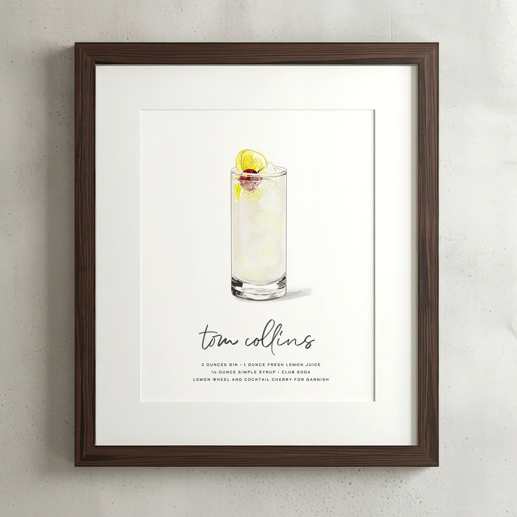 Tom Collins cocktail wall art poster in a walnut frame, hand-drawn recipe illustration with lemon wheel and cherry, 8x10 print