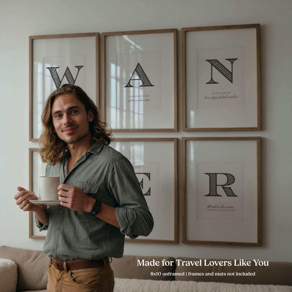 Man holding a cup in a room with framed travel quote wall art prints on the wall.