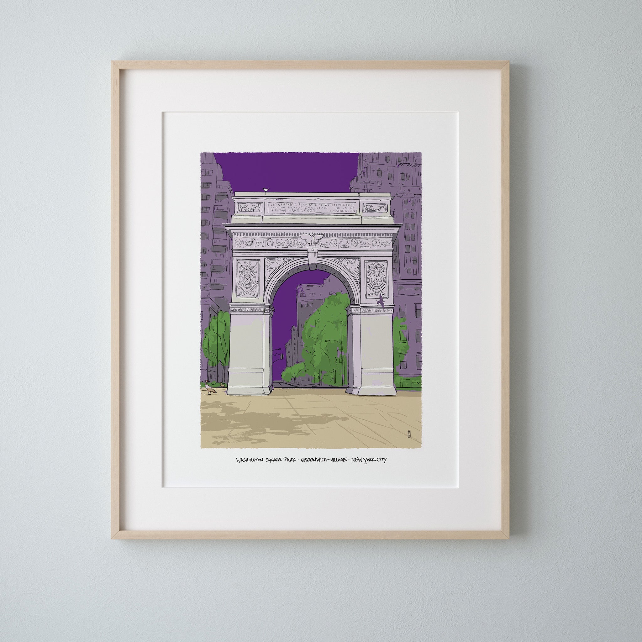 A framed art print of Washington Square Park's arch in New York City at dusk, matted in white with a light wood frame, hung on a light gray wall.