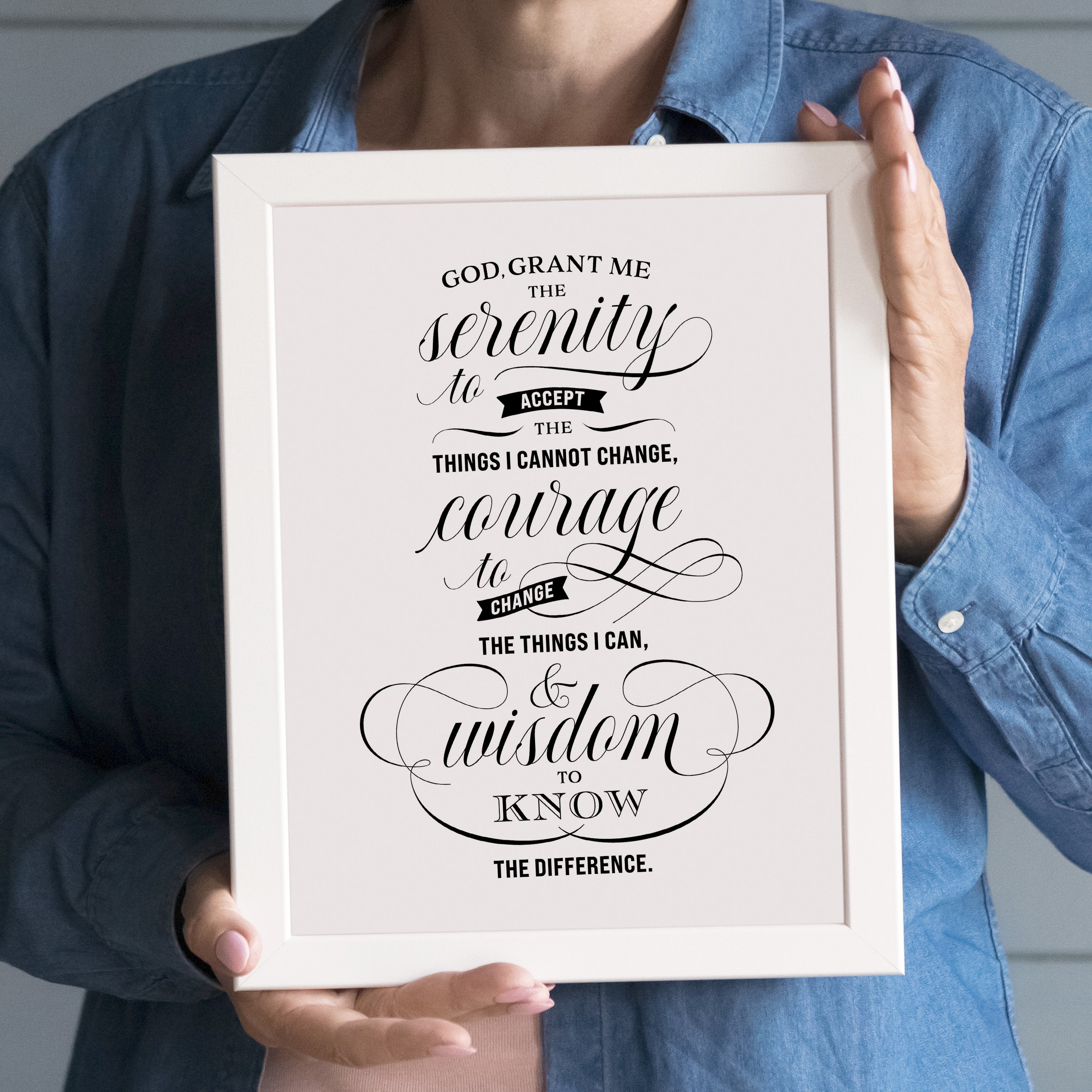 Serenity Prayer wall art in elegant script typography held in white frame - features the full prayer text with decorative calligraphic lettering in black and white