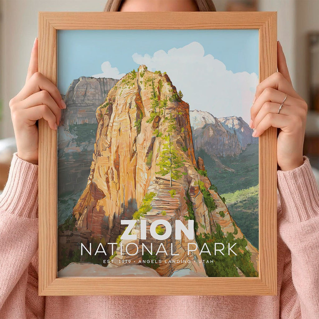 Framed poster of Mod Day Art's Zion National Park held by a person wearing a pink sweater.