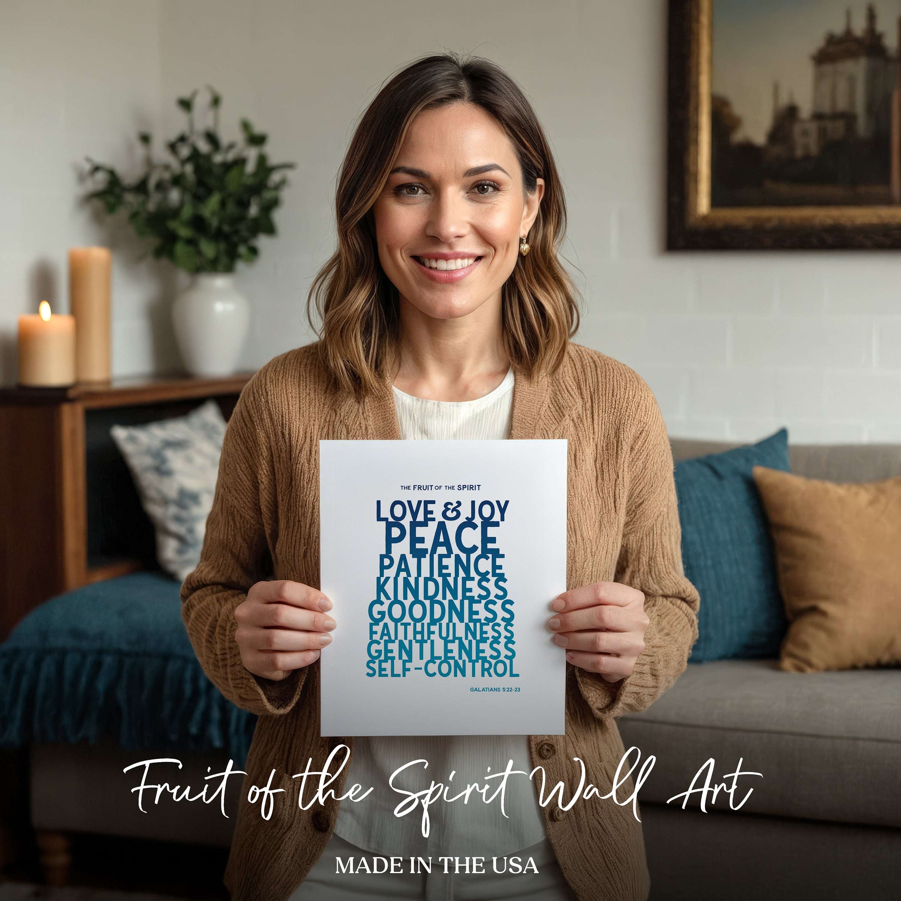 Woman holding a 'Fruit of the Spirit' wall art print in a cozy living room.