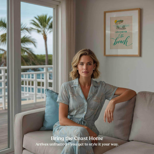 Life is Better at the Beach coastal wall art hanging in a living room with a view of palm trees.