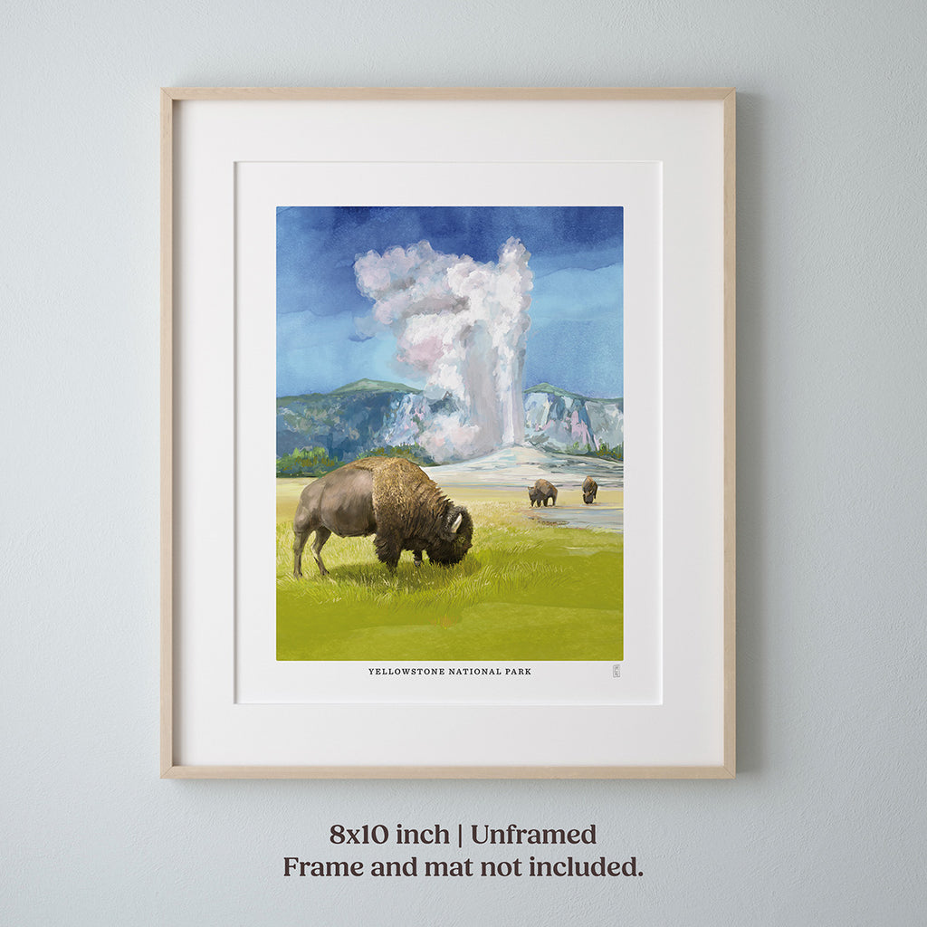 Framed hand-signed artwork of  Yellowstone National Park and a bison in a field with a mountain and cloud background on a gray wall.