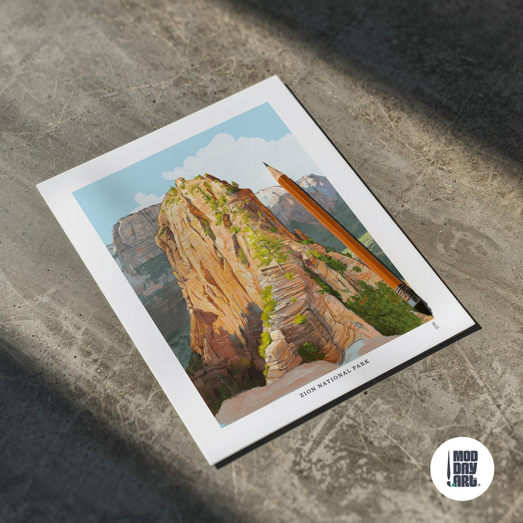 Hand-signed print of Angels Landing in Zion National Park with a pencil on a concrete surface, featuring the brand 'Mod Day Art'.